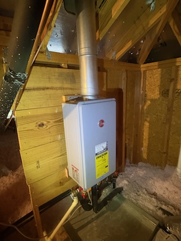 Attic tankless by Livas Contracting Services, Katy TX: Rheem gas unit vented through the roof
