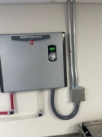 Electric tankless by Livas Contracting Services, Katy TX: Rheem Performance unit wall-mounted