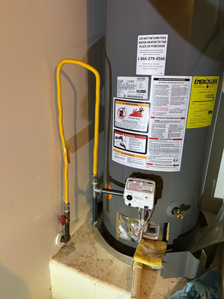 Gas connection at the water heater by Livas Contracting Services, Katy TX: New flex connector and shutoff valve at the heater